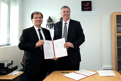 Dr H Nakagama, NCC president, and Dr C P Wild, IARC director, with the signed document